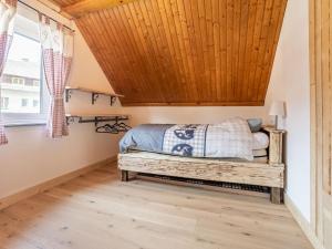a bedroom with a bed and a wooden ceiling at Snug holiday home in Wei briach with terrace in Weissbriach