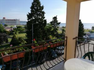 a balcony with plants and a view of a city at Ivet Guest Rooms - Obzor in Obzor