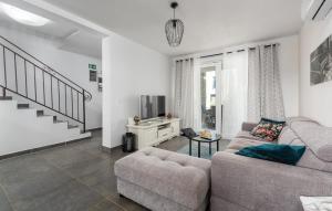 a living room with a couch and a tv at Holiday House Businia with Whirlpool in Bužinija