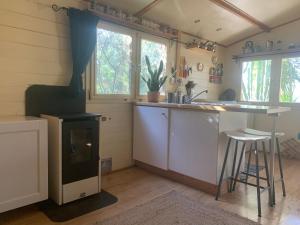 a kitchen with a stove and a sink and a counter at Finca Florecer in Tivenys +14 photos