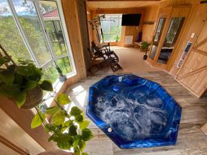 a large blue tub sitting in the middle of a room at KooralBnB in Kooralbyn