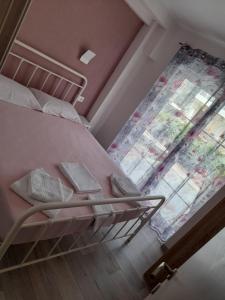 a bunk bed in a room with a window at Perea white suites in Perea