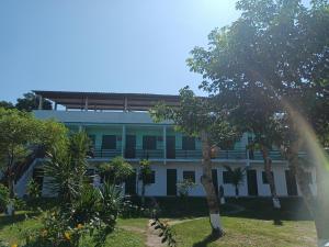 a building with a rainbow in front of it at Pousada Vale Do Aijalom in Cabo Frio