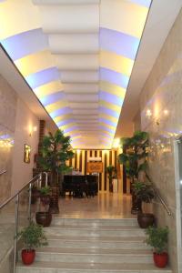 a lobby with a yellow and blue ceiling at Lavina Hotel Apartments in Sakakah