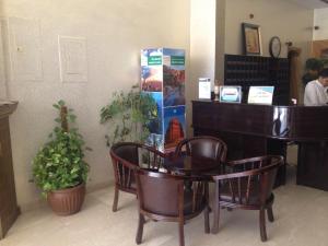 a store with a table and chairs in a room at Lavina Hotel Apartments in Sakakah