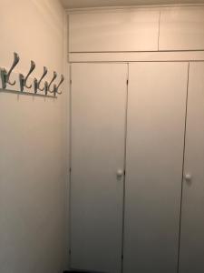 a closet with two white cabinets and hangers at Gemütliche Ferienwohnung in Altreichenau in Altreichenau