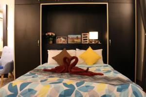 a bed with a red bow on top of it at MLH Premier Suites @ Saville Cheras in Cheras