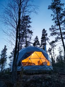 a tent is set up in the woods at Hidden Island Laukanharju Glamping in Savonlinna