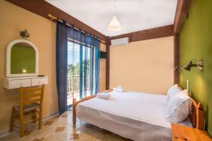 a bedroom with a large bed and a window at Southgate Apartments in Agios Georgios