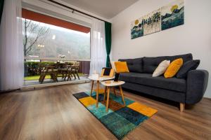 a living room with a couch and a table at Home & Garden with stunning view in Sinaia