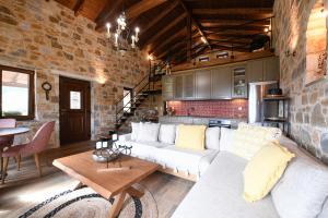 a living room with a white couch and a brick wall at Pinelia Home in Mirtófiton