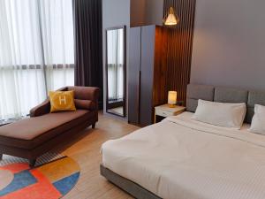 a hotel room with a bed and a chair at The Parkville - Bangsar Trade Centre in Kuala Lumpur