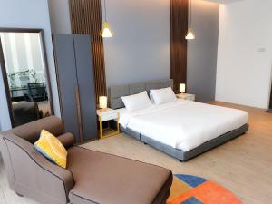 a bedroom with a bed and a couch in it at The Parkville - Bangsar Trade Centre in Kuala Lumpur