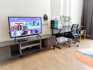 a living room with a television on a desk at The Parkville - Bangsar Trade Centre in Kuala Lumpur +13 photos