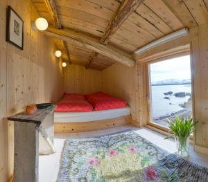 a bed in a tiny house with a window at The Steamery in Kvalnes