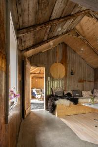 a bedroom with a bed in a room with wooden walls at Villa Lofoten - The Steamery in Kvalnes