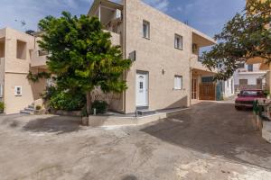 a house with a driveway in front of it at Guests Apartments in Sissi Creta in Sissi