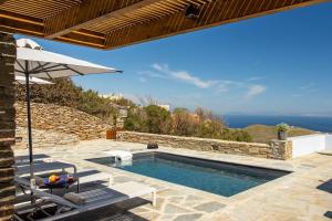 a swimming pool with a view of the ocean at Nevermind Vacations villa A in Kastrianí
