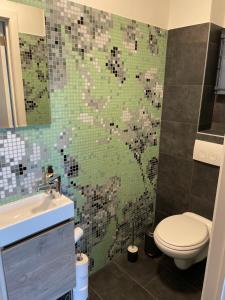 a bathroom with a toilet and a sink at La Vie En Rose in Muno +12 photos
