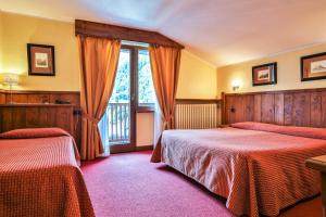 Postel nebo postele na pokoji v ubytování Hotel Crampon
