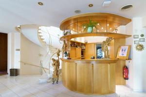 a room with a counter with statues in it at Hotel Sonne in Gottmadingen