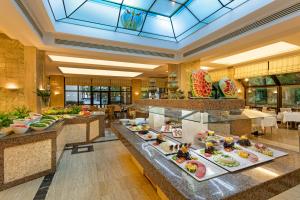 a buffet in a hotel with many plates of food at Özkaymak Falez Hotel in Antalya