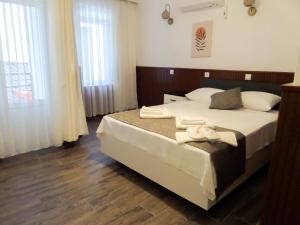 a bedroom with a large bed and a large window at Zulu Hotel in Kumluca