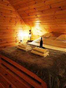 a bedroom with a bed in a wooden room at Domki przy plaży in Ryn