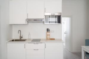 A kitchen or kitchenette at White Gioberti Apartments