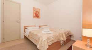 a bedroom with a bed with two towels on it at Apartments Nikolina in Split