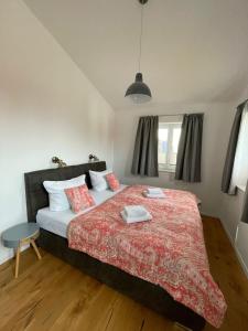 a bedroom with a large bed with a red blanket at Reusenhaus Nord in Breege