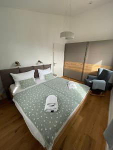 a bedroom with a large bed and a chair at Reusenhaus Nord in Breege