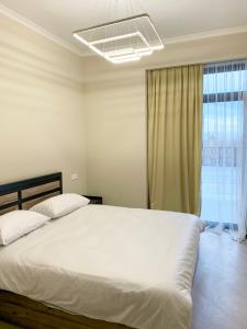 um quarto com uma grande cama branca e uma janela em Uparthotel em Tsaghkadzor