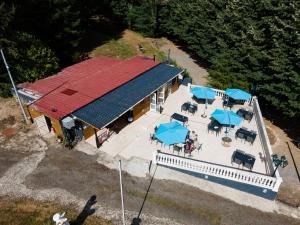 an overhead view of a building with tables and umbrellas at Camping Les Roussilles in Saint-Sylvestre