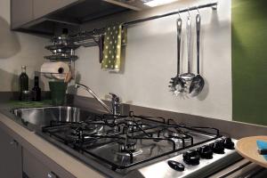 a kitchen with a stove and a sink at Dante 12 in Vigevano