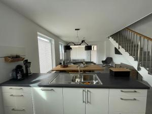 a kitchen with a sink and a staircase at Reusenhaus Süd in Breege
