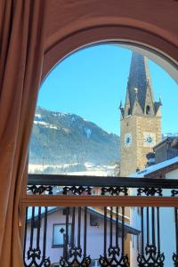 einen Blick auf einen Uhrturm aus einem Fenster in der Unterkunft City Apartment Hornblick in Kitzbühel