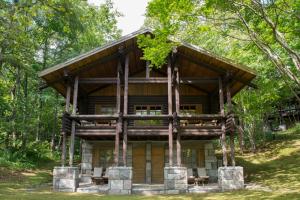 a log cabin in the woods with trees at Hotel Nidom in Tomakomai