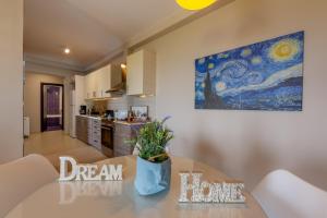 a kitchen with a table and a painting on the wall at Villa Kos View 2 in Kos