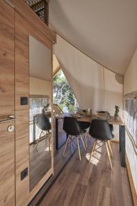 a dining room with a table and chairs at Villaggio Camping Odissea in Marina di Camerota
