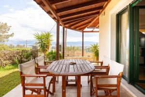 a wooden table and chairs on a patio at Luxury Villa in Agios Nikolaos with private pool in Agios Nikolaos