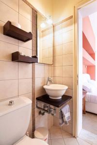 a bathroom with a sink and a toilet and a mirror at Luxury Villa in Agios Nikolaos with private pool in Agios Nikolaos
