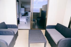 a room with two couches and a door with a balcony at Studio Jacaranda in Santiago del Teide +7 photos