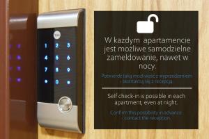 a sign next to an apple remote control at Apartments IN - Bandurskiego in Szczecin