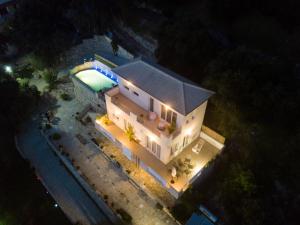 an overhead view of a house with a pool at night at Villa Douros in Parga