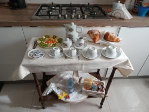a table with a tea set on it in a kitchen at Domus In Fonte in Scafati