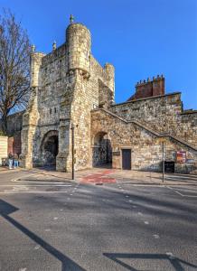 a large stone building with a staircase on it at York Staycation with Free Parking in York