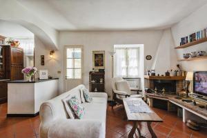a living room with a couch and a tv at Villa Rica by Wonderful Italy in Santa Margherita Ligure