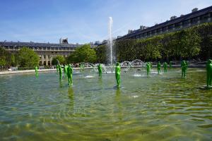 a group of people in green suits in a fountain at Hotel Montpensier in Paris