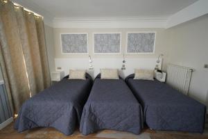 Un ou plusieurs lits dans un hébergement de l'établissement Hotel Montpensier